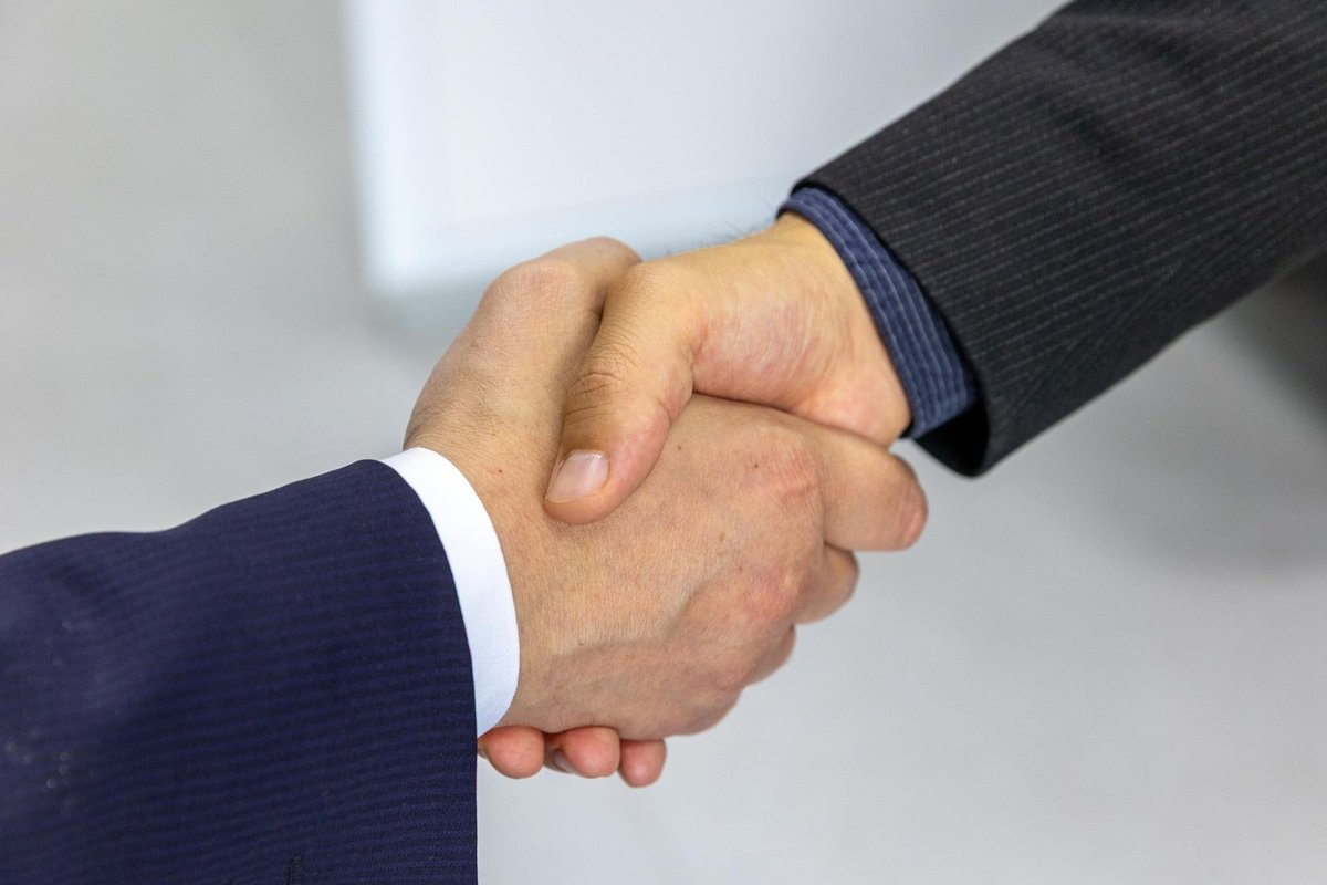 Two BM360 consultants reviewing documents together at a desk